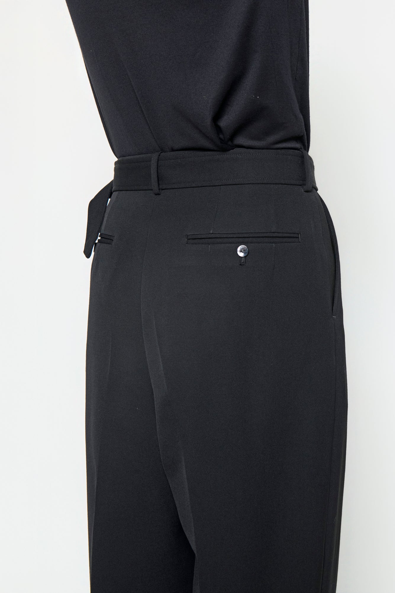 BELTED TAILORED TROUSERS in black wool gabardine